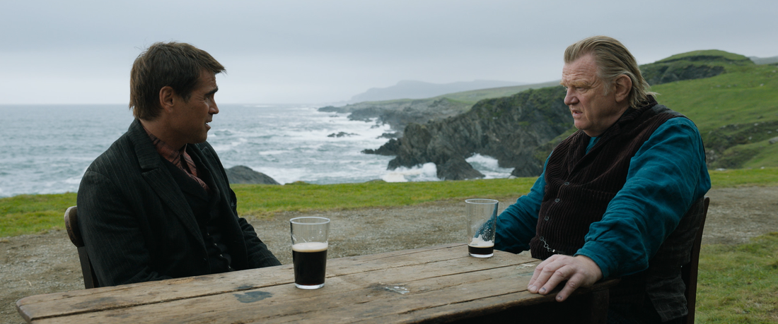 photo of two men sat on the cliffs of Ireland