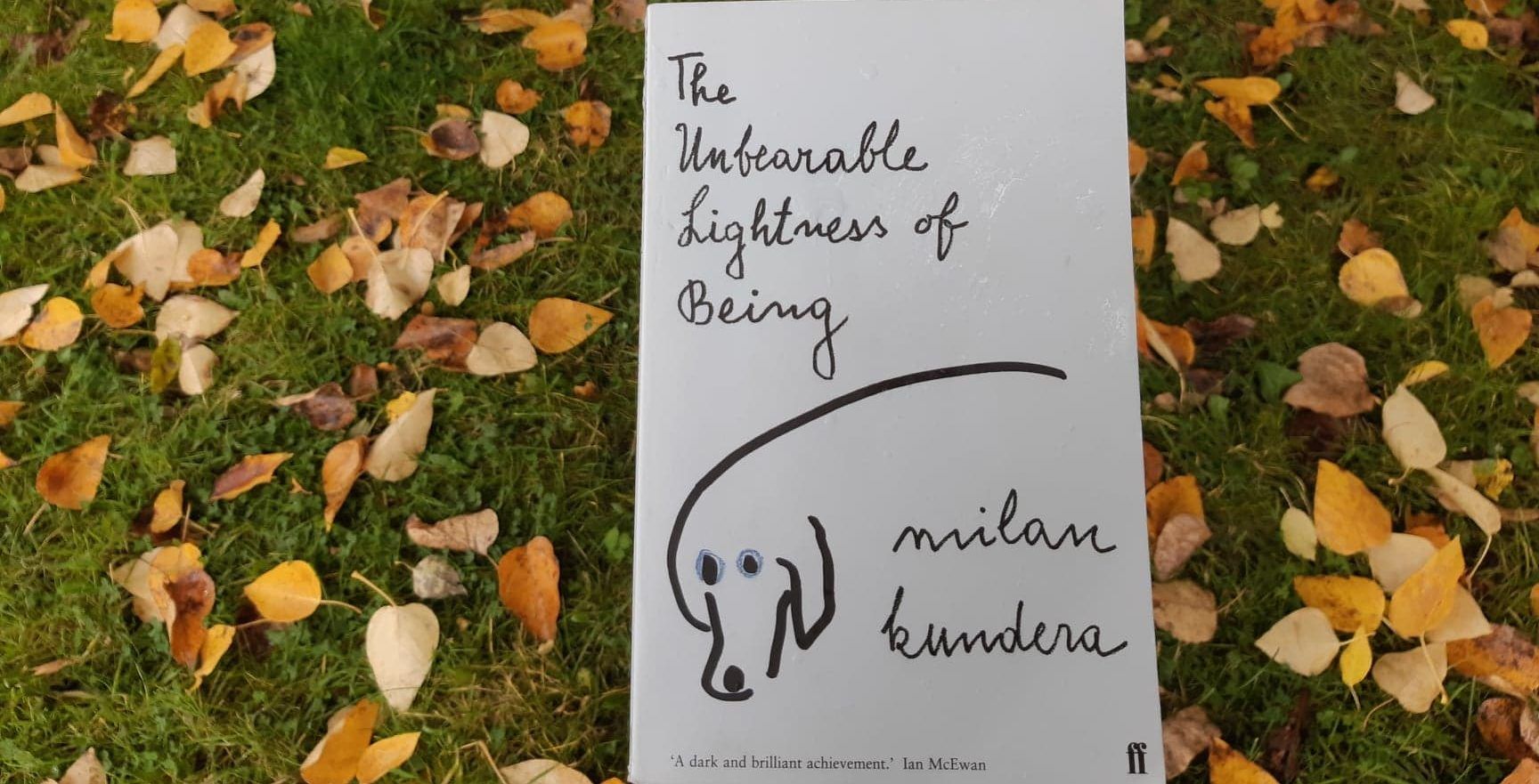 Photo of The Unbearable Lightness of Being by Milan Kundera against the backdrop of leaves