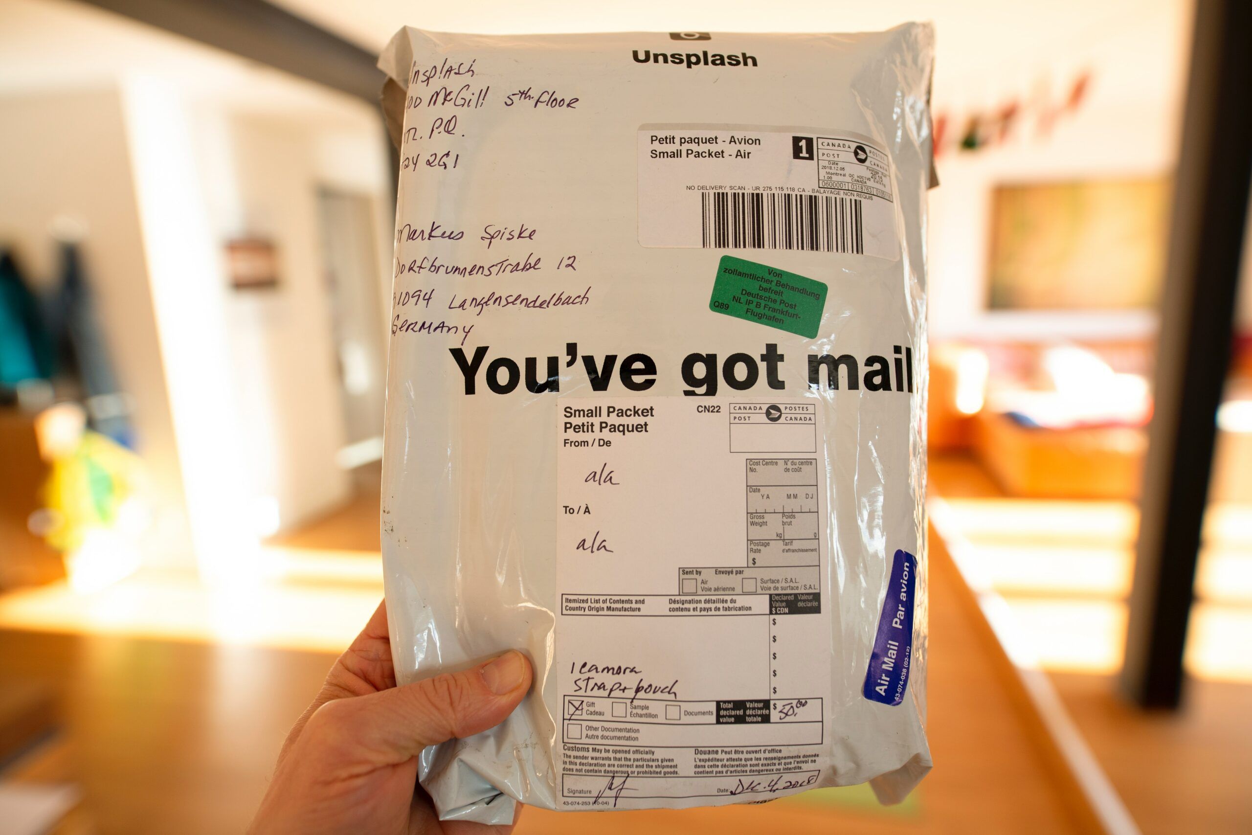 Image of a hand holding a package reading 'you've got mail'