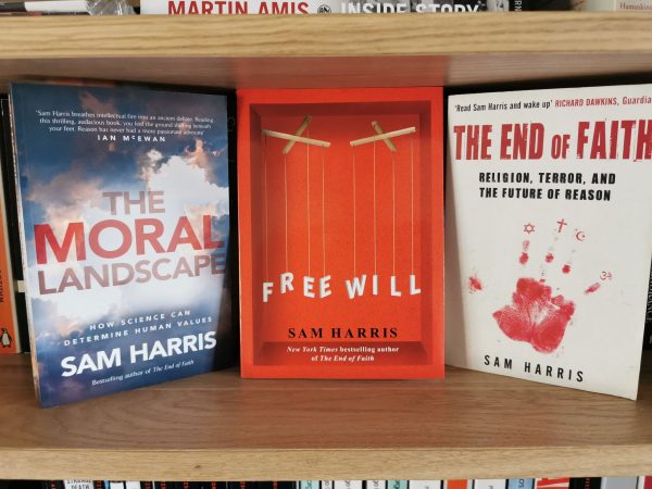 Free Will by Sam Harris on a shelf alongside other novels by the author