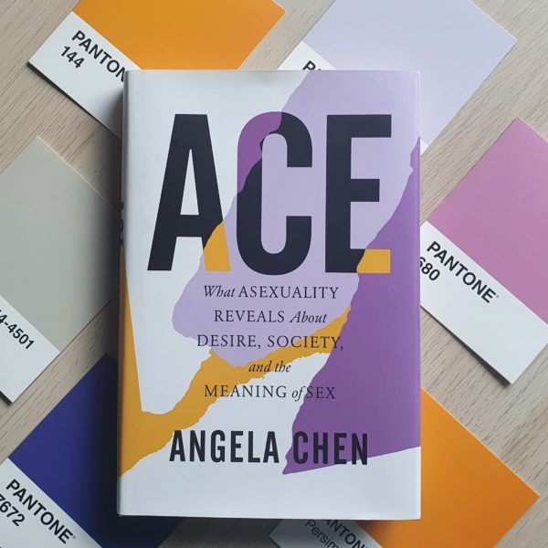 The book "Ace" laid on top of 6 Pantone postcards of similar colours to the book cover
