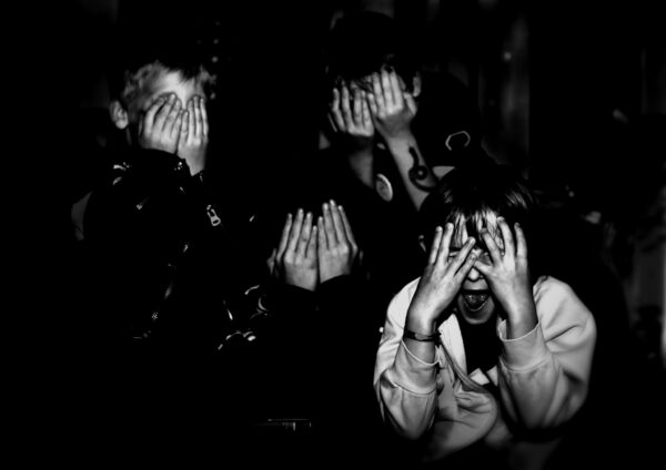 black and white photo of children covering their faces