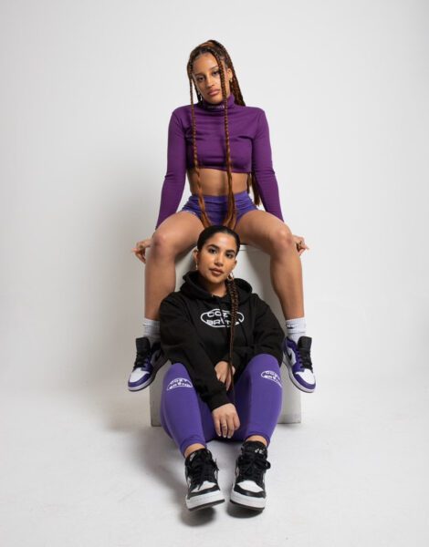 Two female models wearing the cozybrvnd's newest products in purple and black