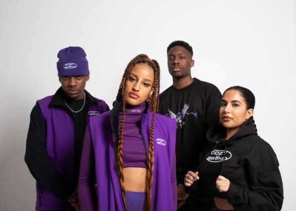 Two female models and two male models wearing the Cozybrvnd's newest collection in purple and black