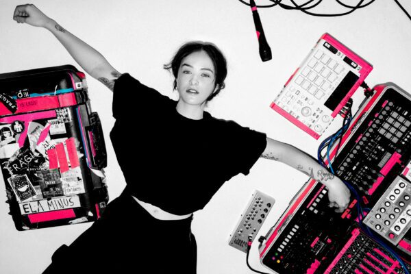 Electro-pop and monochromatic image of Ela Minus amongst her synthesizers.
