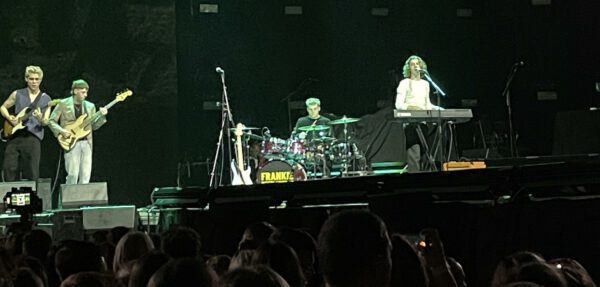 Frankie Beetlestone and guitarist Toby (far left), bassist Caleb (left), and drummer Dan (centre) performing at AO Arena, Manchester – Photo: Callum Webb @ The Mancunion