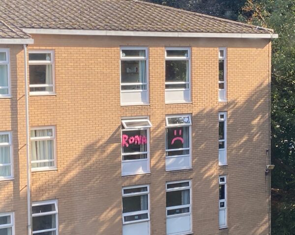 Isolating students have put signs in their windows to let others know they have the virus. Photo: Carlo Di Giammarino