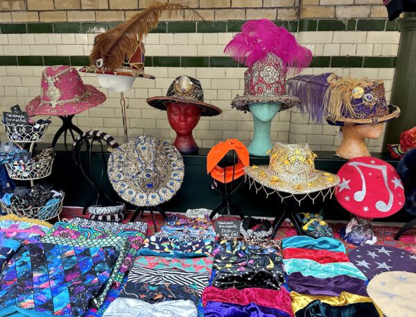 A collection of hats and scarves on display on a table
