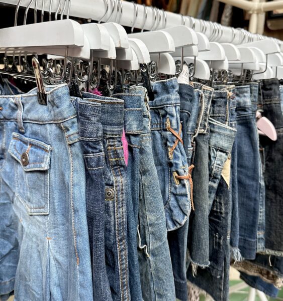 A photo of denim skirts hung up on a rail