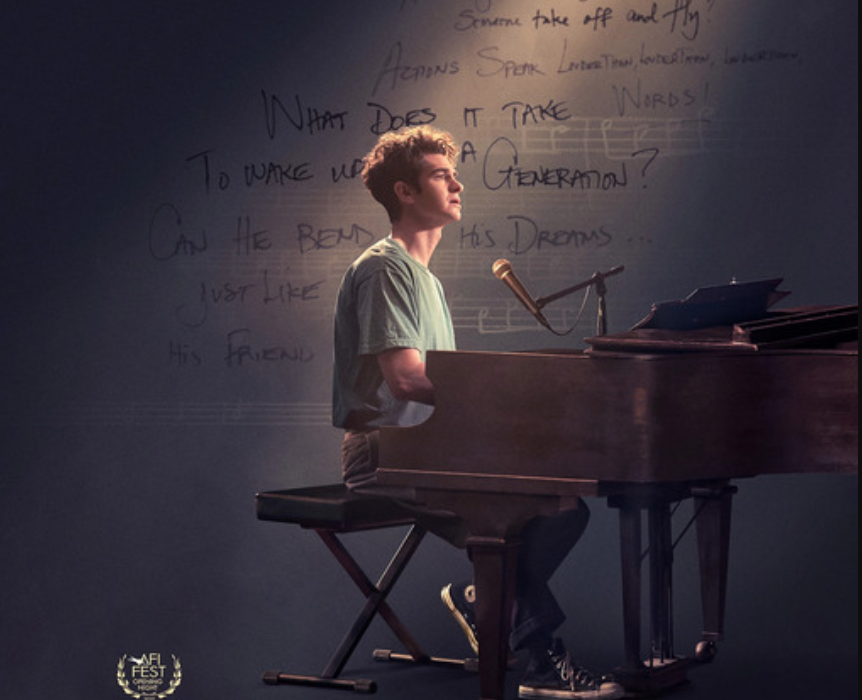 Andrew Garfield as Jonathan Larson playing the piano