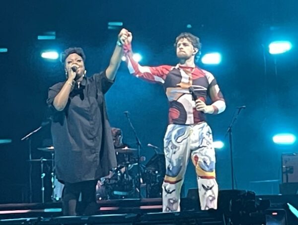 Tom Grennan performing "Let's Go Home Together" with backup singer Angel at AO Arena, Manchester – Photo: Callum Webb @ The Mancunion