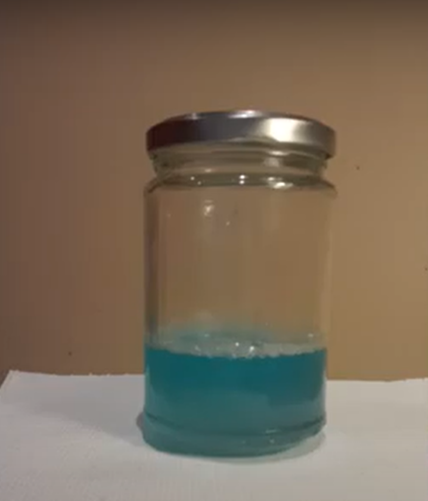 This image shows a jar containing blue liquid.