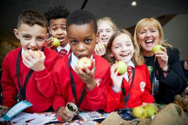 Image shows pupils participating in workshops to learn about food choices impact and climate change