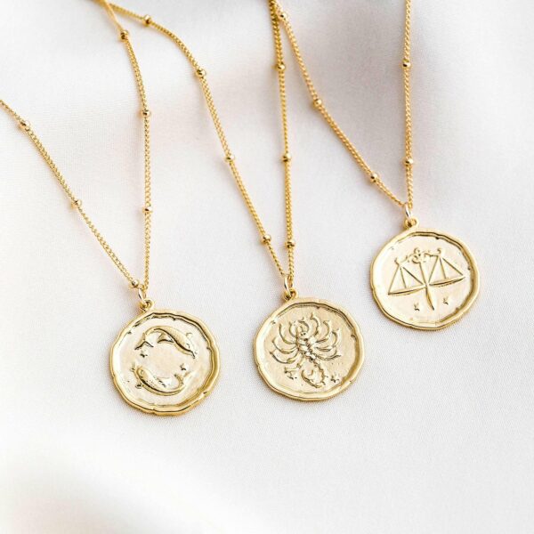 Gold pendant necklaces with zodiac sign prints